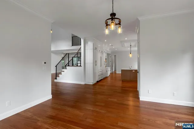 a view of a kitchen with wooden floor and a ceiling fan
