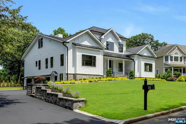 a front view of a house with a garden and yard
