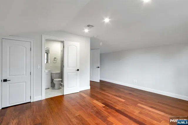 wooden floor in an empty room with a gallery
