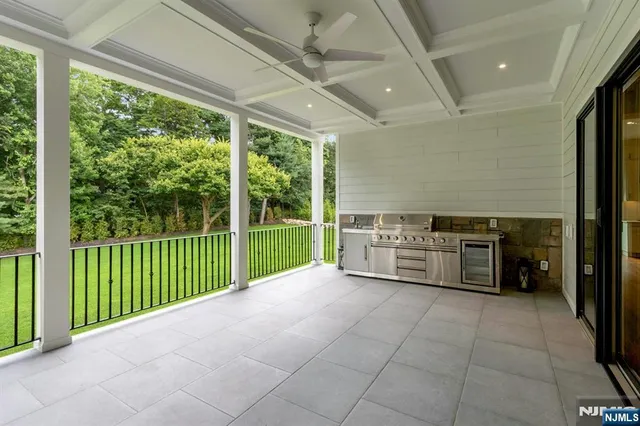 an aerial view of a house with swimming pool garden and patio