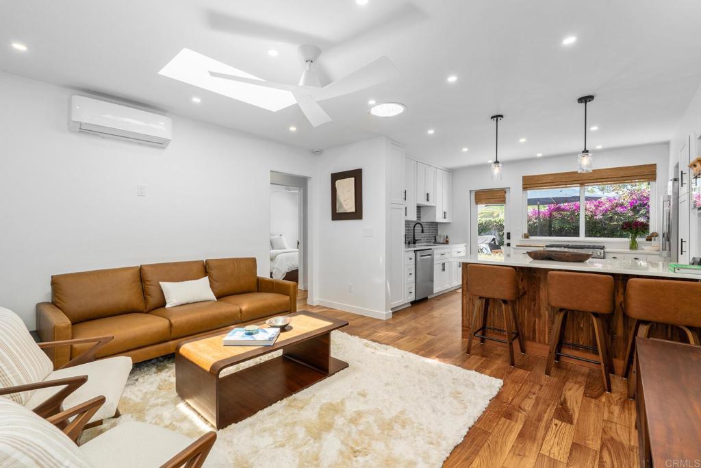 219 24th Street Del Mar, CA 92014 - Photo 4 of 15 a living room with furniture a rug and kitchen view