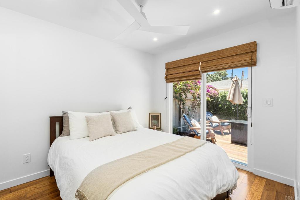 219 24th Street Del Mar, CA 92014 - Photo 10 of 15 a bedroom with a large bed and a large window with outer view