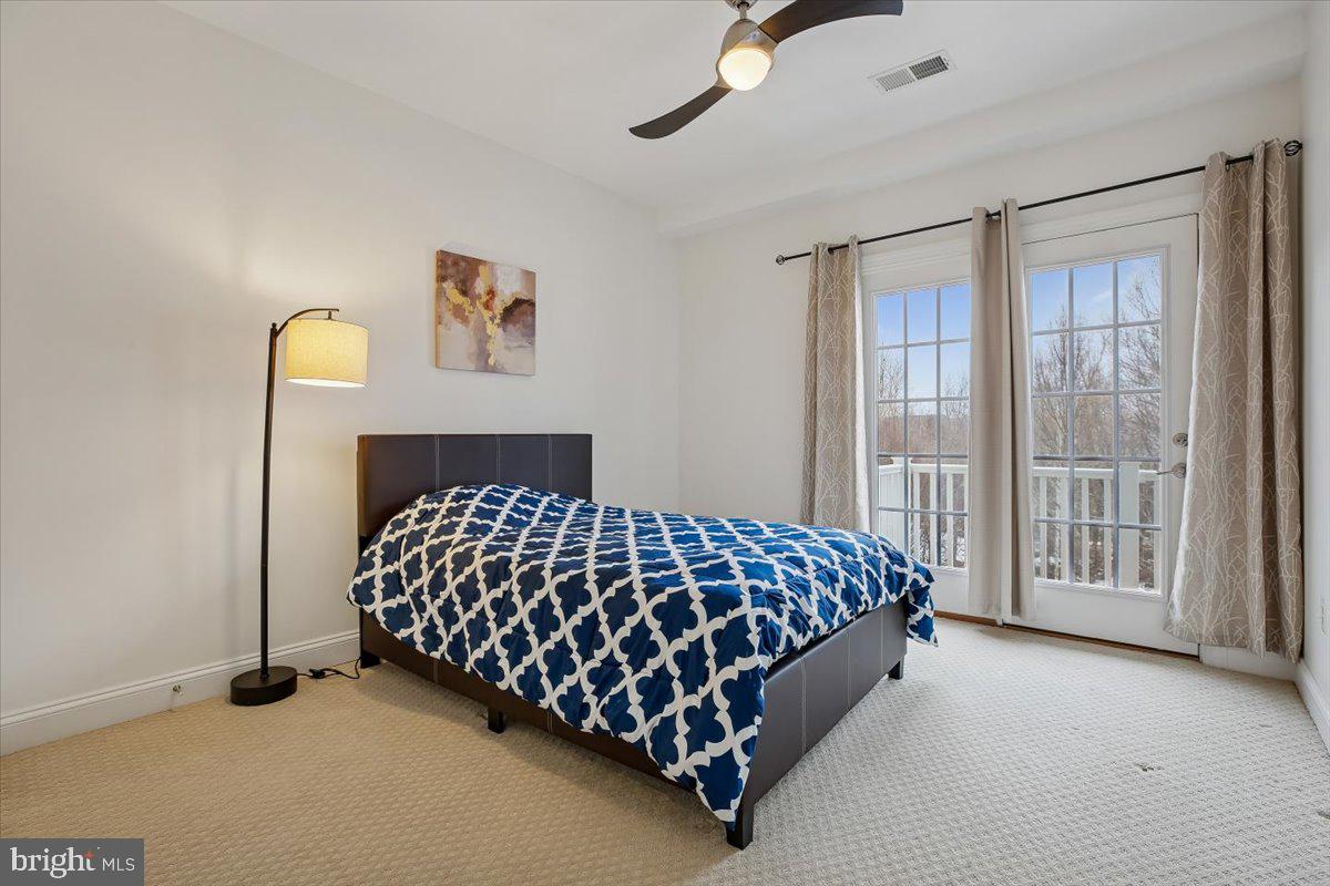 452 Exchange Avenue Gaithersburg, MD 20878 - Photo 13 of 37 a bed sitting in a bedroom next to a window