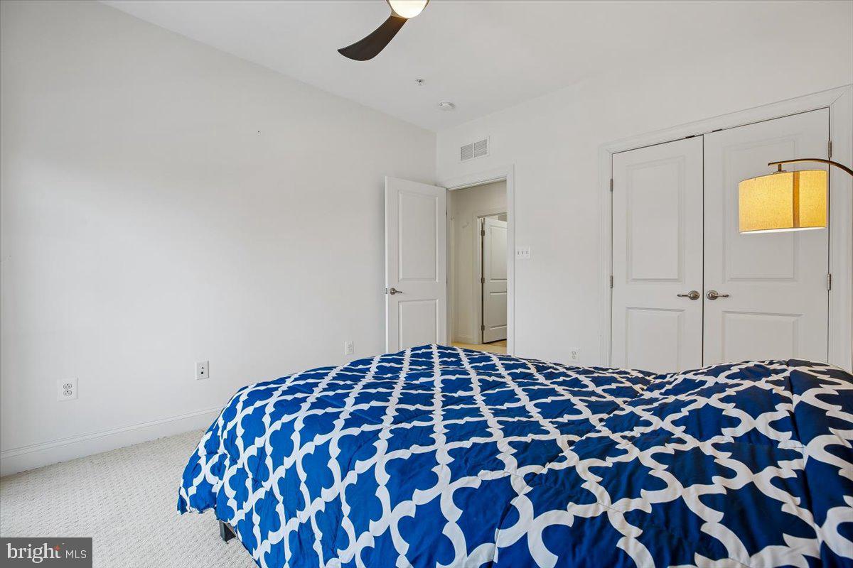 452 Exchange Avenue Gaithersburg, MD 20878 - Photo 14 of 37 a bedroom with a bed and a lamp