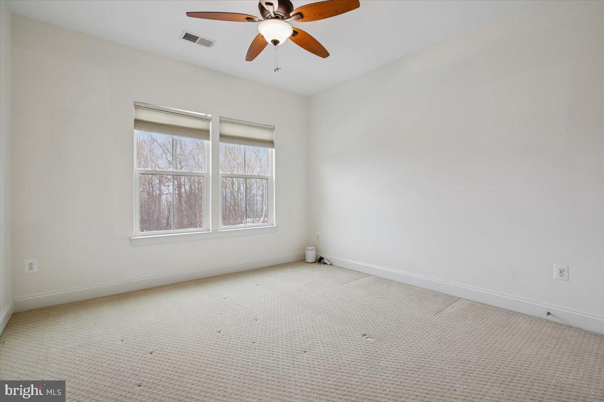 452 Exchange Avenue Gaithersburg, MD 20878 - Photo 15 of 37 an empty room with windows and fan