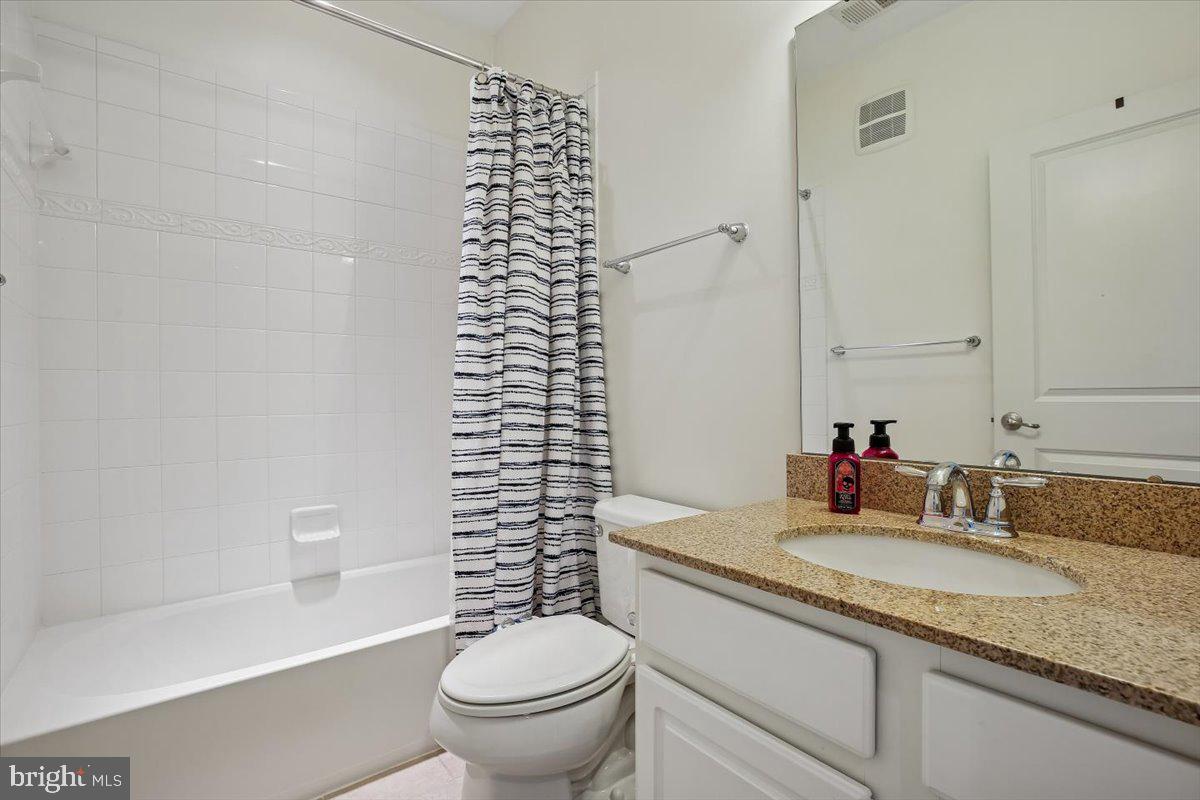452 Exchange Avenue Gaithersburg, MD 20878 - Photo 17 of 37 a bathroom with a granite countertop sink toilet and shower