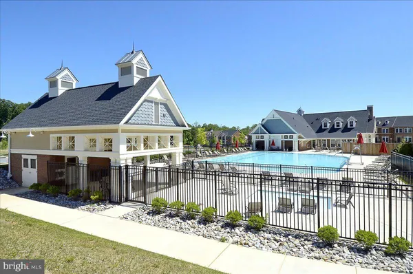 a view of a swimming pool and lounge chairs