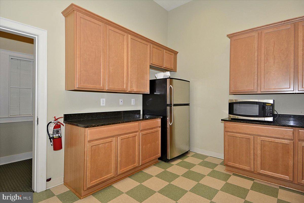 452 Exchange Avenue Gaithersburg, MD 20878 - Photo 27 of 37 a kitchen with stainless steel appliances granite countertop a refrigerator and a stove