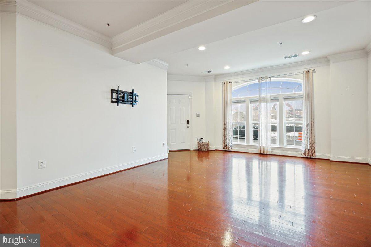 452 Exchange Avenue Gaithersburg, MD 20878 - Photo 4 of 37 a view of an empty room with wooden floor and a window