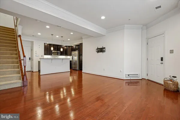 a kitchen with stainless steel appliances kitchen island granite countertop a sink stove and refrigerator