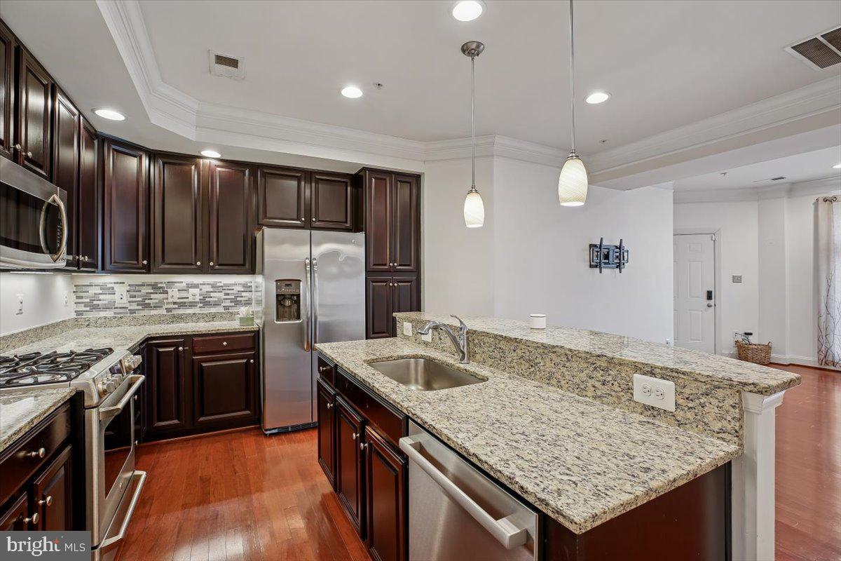 452 Exchange Avenue Gaithersburg, MD 20878 - Photo 6 of 37 a kitchen with stainless steel appliances granite countertop a sink stove and refrigerator