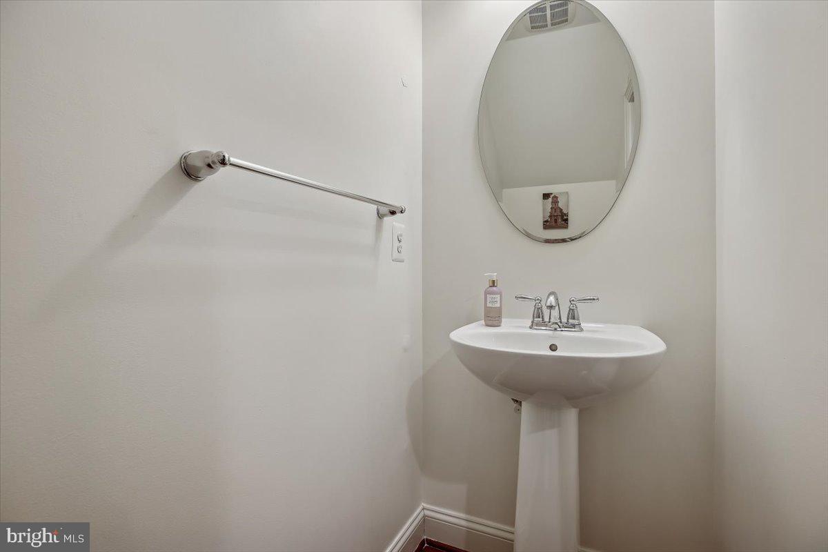 452 Exchange Avenue Gaithersburg, MD 20878 - Photo 8 of 37 a bathroom with a sink a mirror and a shower