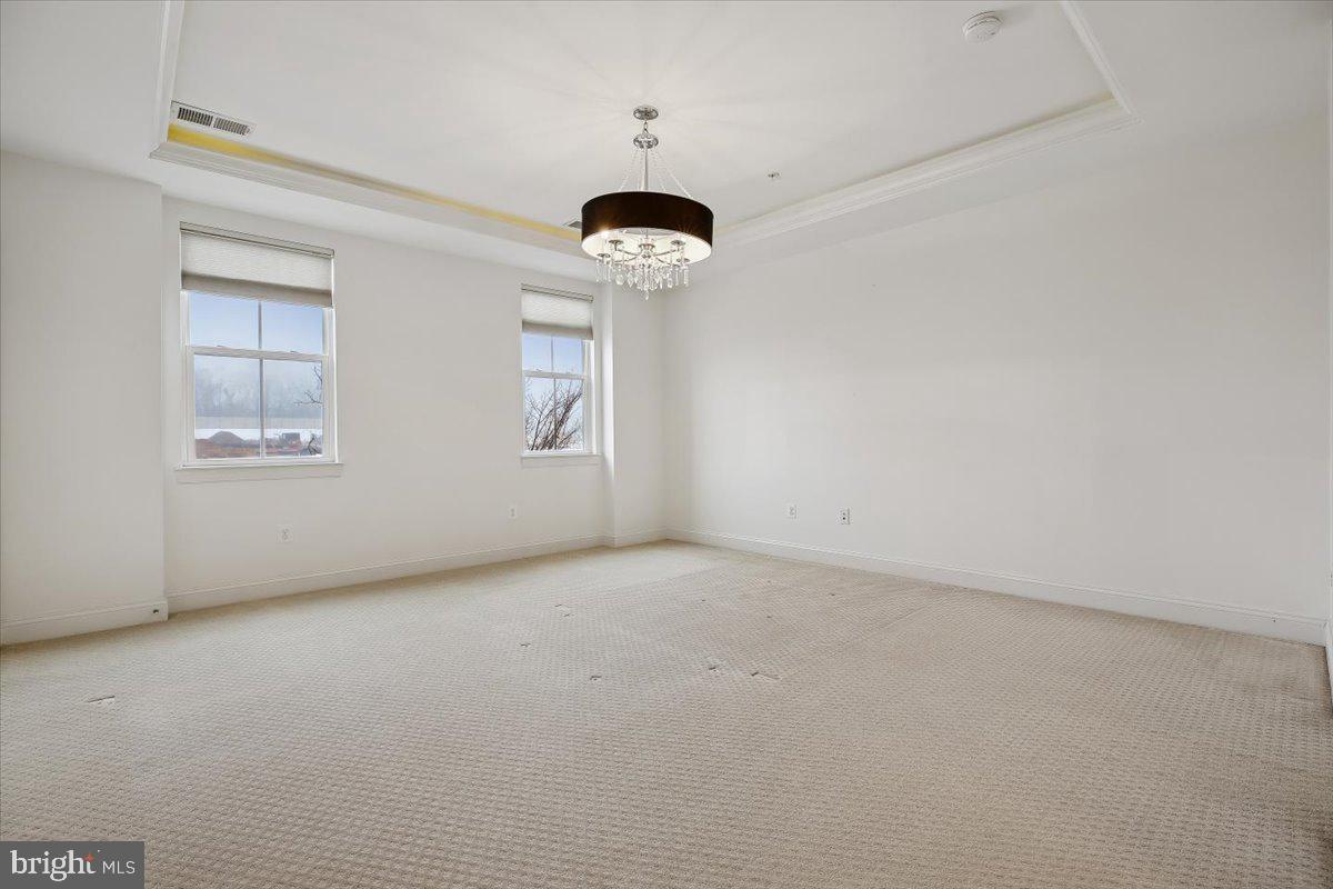 452 Exchange Avenue Gaithersburg, MD 20878 - Photo 10 of 37 an empty room with windows and a ceiling fan