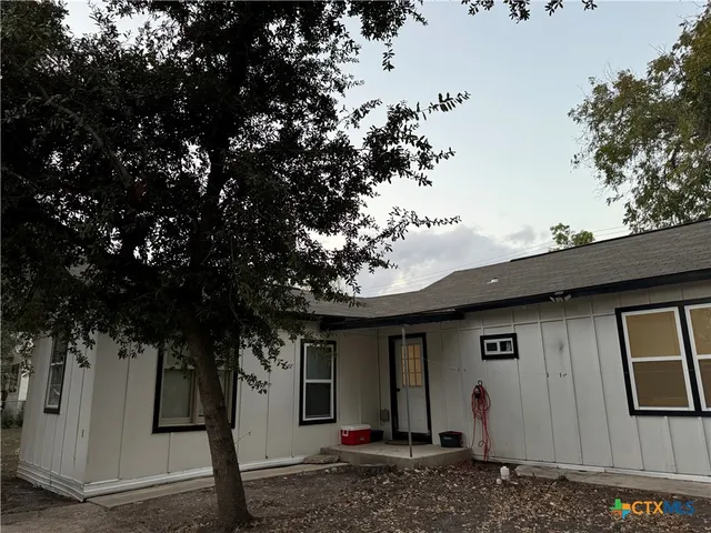 a view of a house with a tree