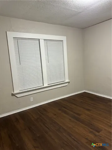 a view of a small space with wooden floor