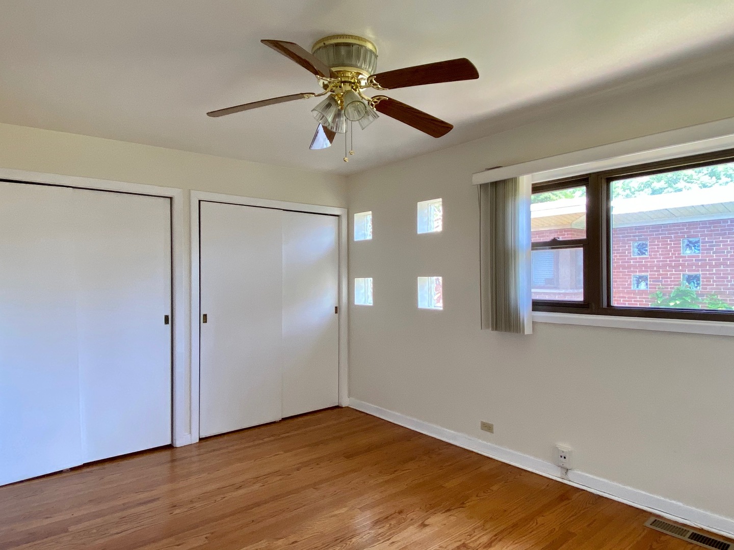 511 Ridge Road, Unit 511 Wilmette, IL 60091 - Photo 12 of 14 an empty room with wooden floor fan and windows