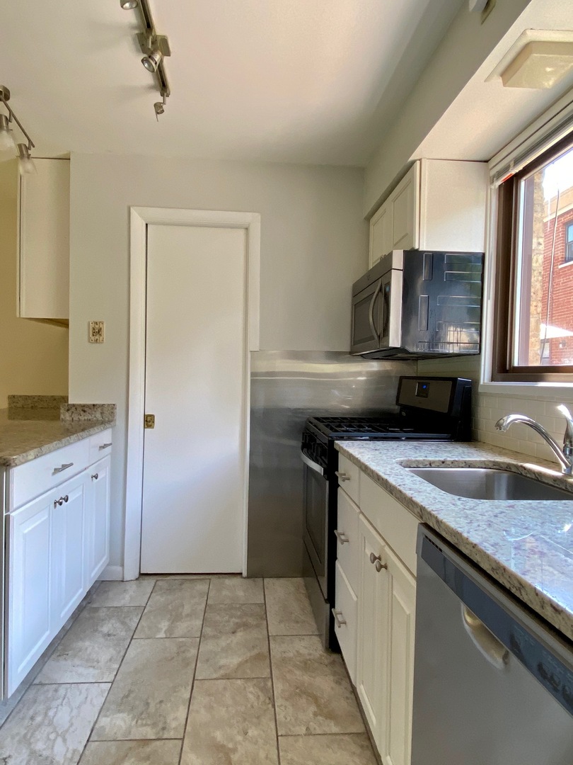 511 Ridge Road, Unit 511 Wilmette, IL 60091 - Photo 7 of 14 a kitchen with a sink and a refrigerator