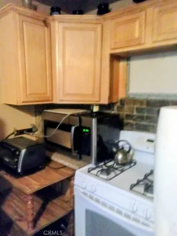 a kitchen with a stove and a refrigerator