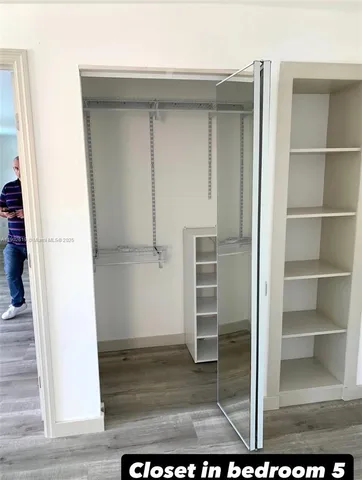 a view of closet area with empty racks