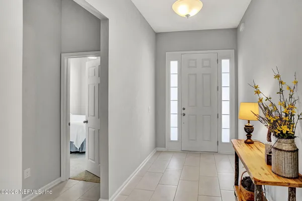 a kitchen with a refrigerator and a stove top oven