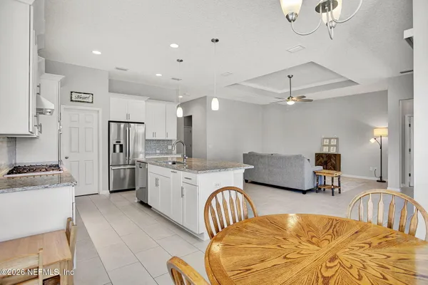 a living room with furniture and kitchen view