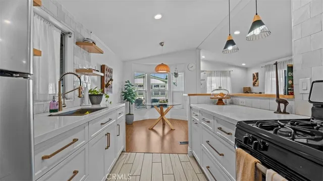 a large kitchen with stainless steel appliances granite countertop a stove and cabinets
