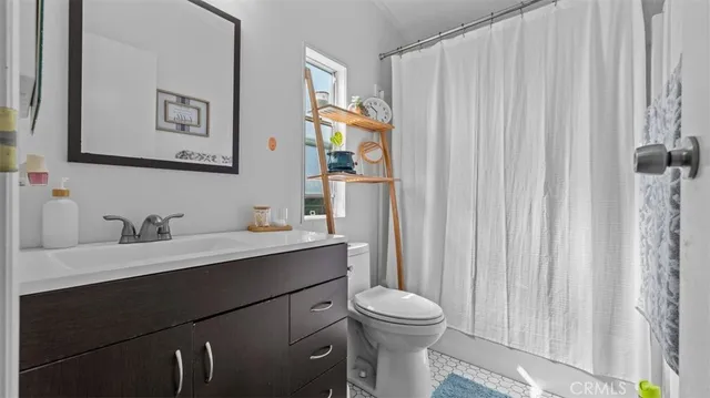 a bathroom with a toilet a sink and a mirror