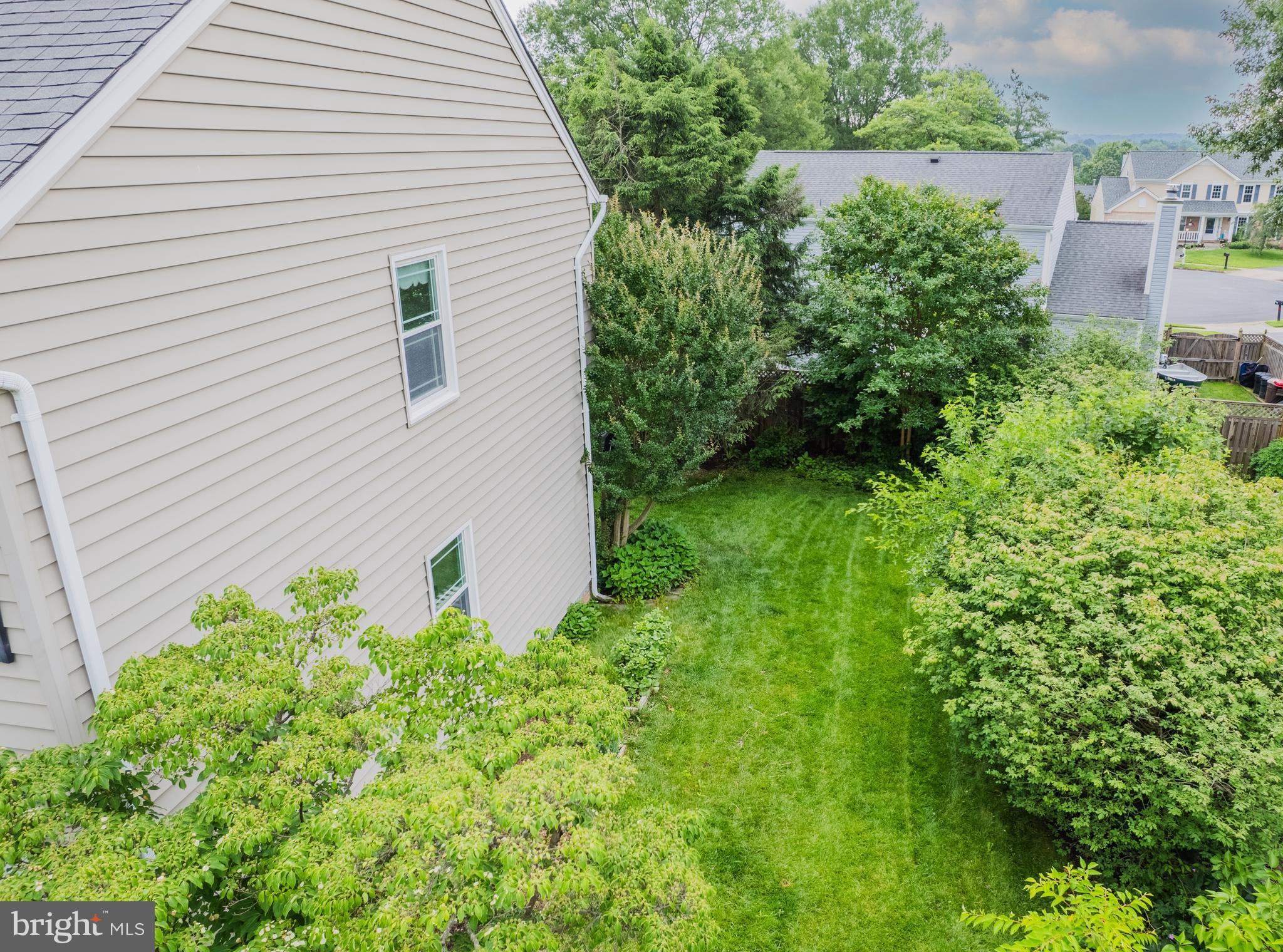 1439 Millikens Bend Road Herndon, VA 20170 - Photo 35 of 46 a backyard of a house with plants and outdoor seating