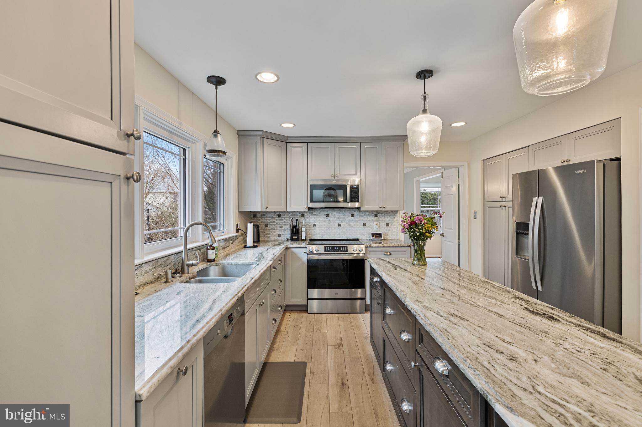 1439 Millikens Bend Road Herndon, VA 20170 - Photo 4 of 46 a large kitchen with a stove refrigerator sink and cabinets