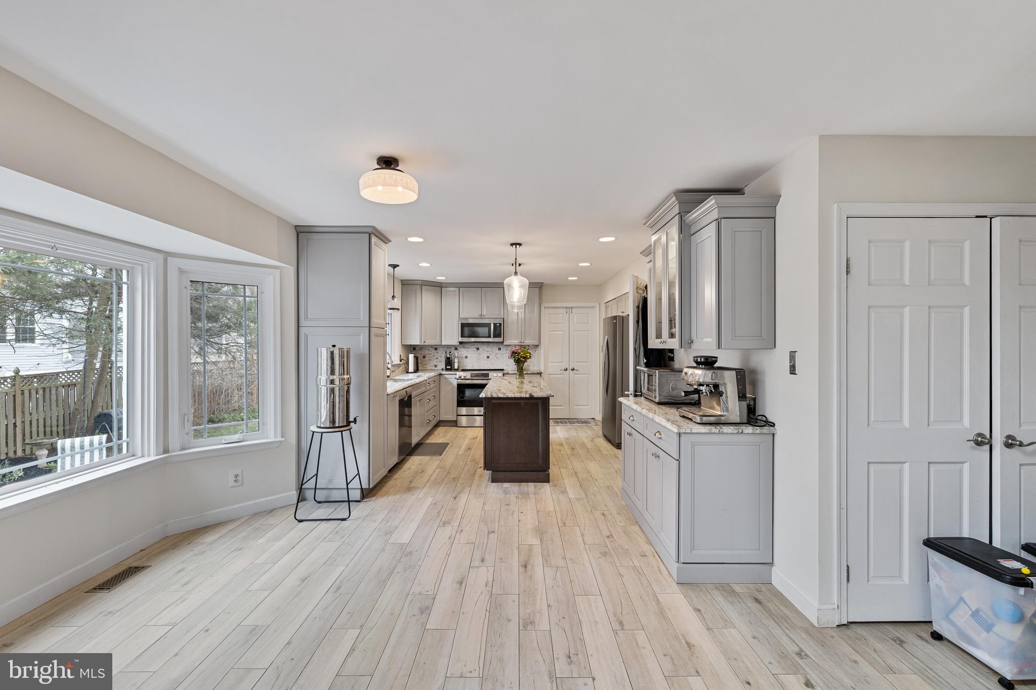 1439 Millikens Bend Road Herndon, VA 20170 - Photo 41 of 46 a large open kitchen with a large window a sink and stainless steel appliances