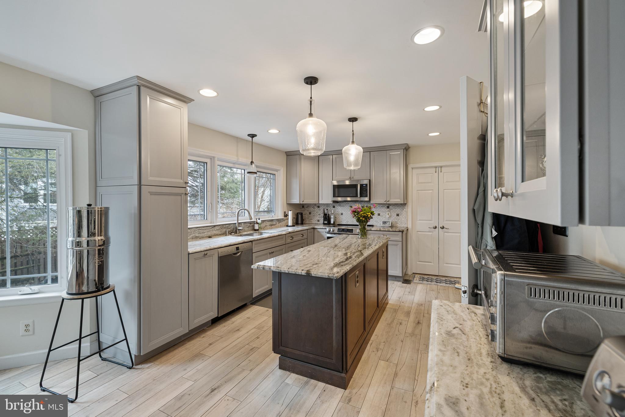 1439 Millikens Bend Road Herndon, VA 20170 - Photo 42 of 46 a kitchen with granite countertop a stove a sink a refrigerator and a living room view