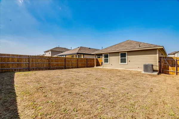 a view of a house with a backyard