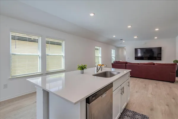 a kitchen with a stove a sink and a microwave