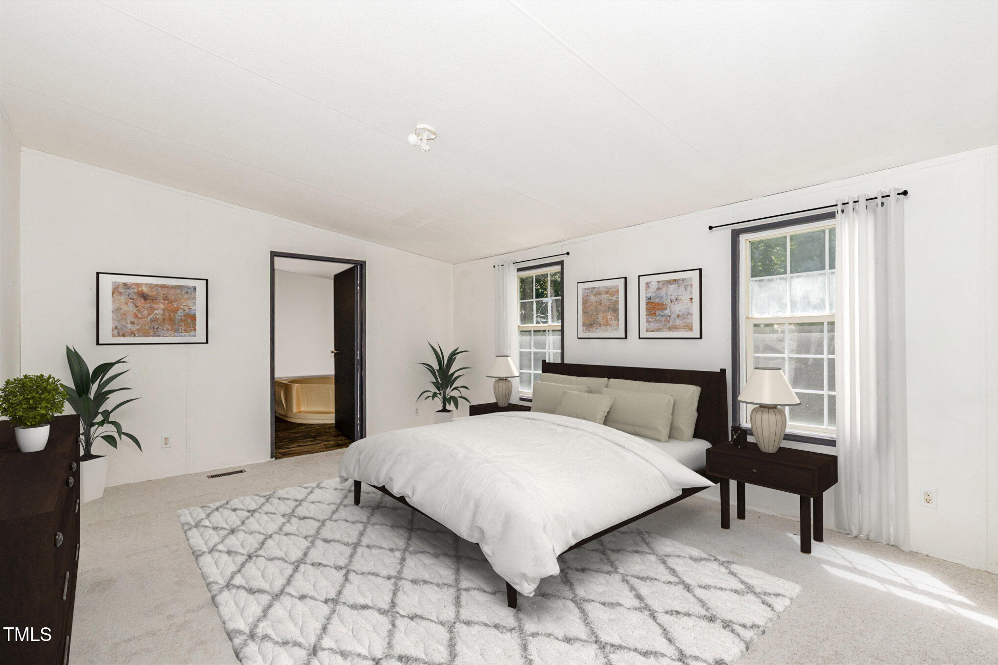 548 Riddle Avenue Hillsborough, NC 27278 - Photo 4 of 12 a bedroom with a large bed and a potted plant