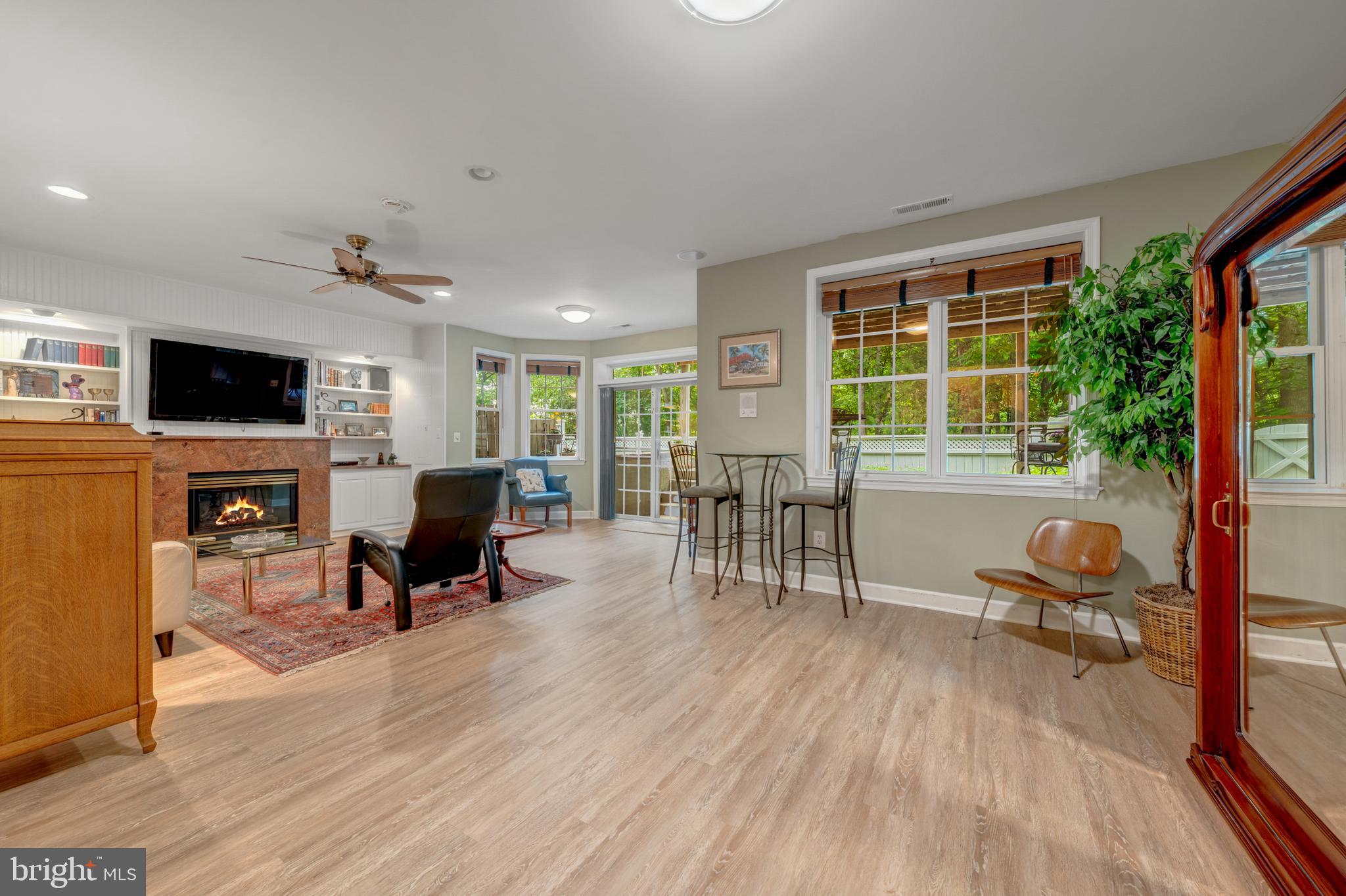 1925 Logan Manor Drive Reston, VA 20190 - Photo 30 of 61 a living room with furniture a fireplace and a flat screen tv