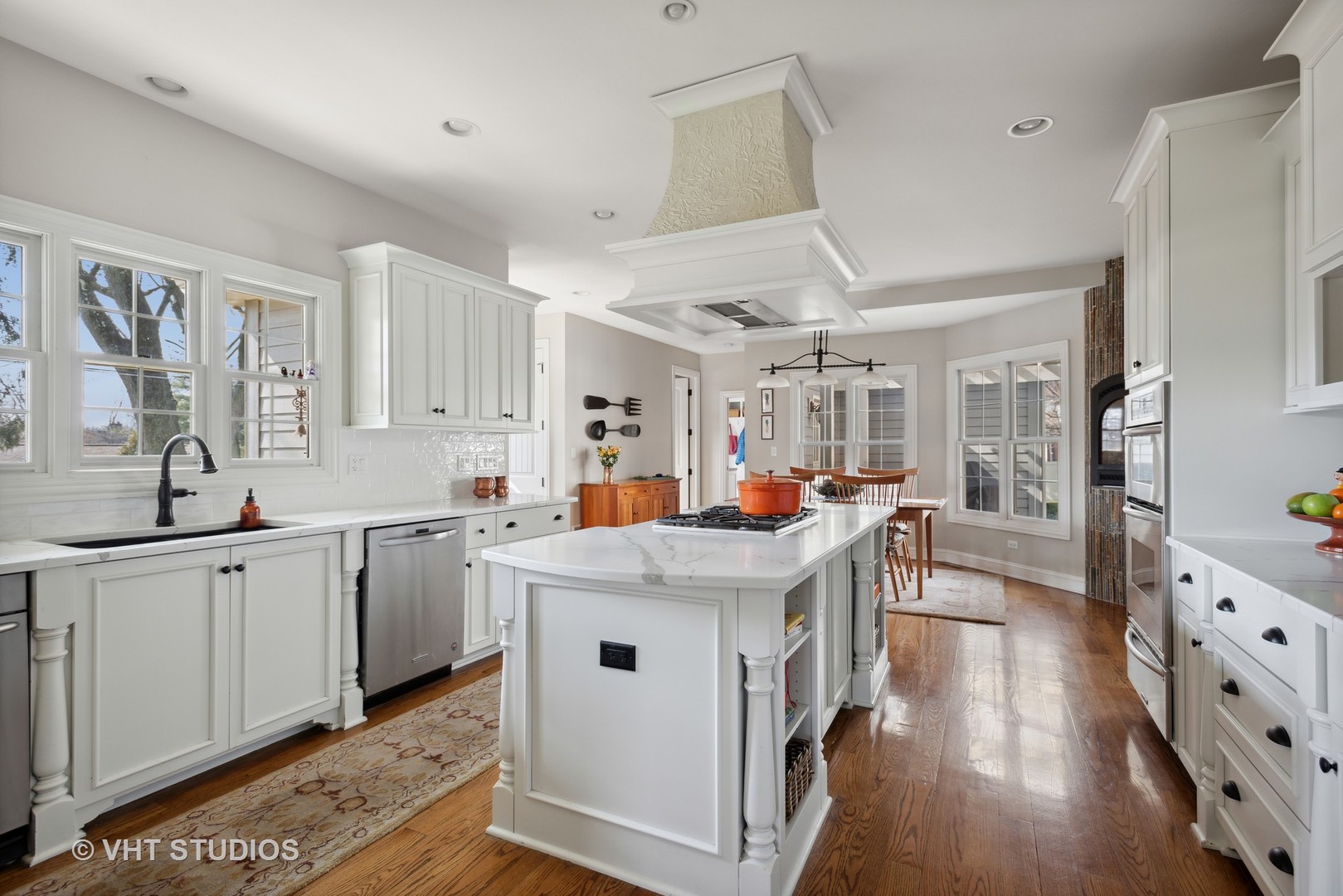1044 Golf Lane Wheaton, IL 60189 - Photo 14 of 43 a kitchen that has a lot of cabinets a sink a stove and wooden floor