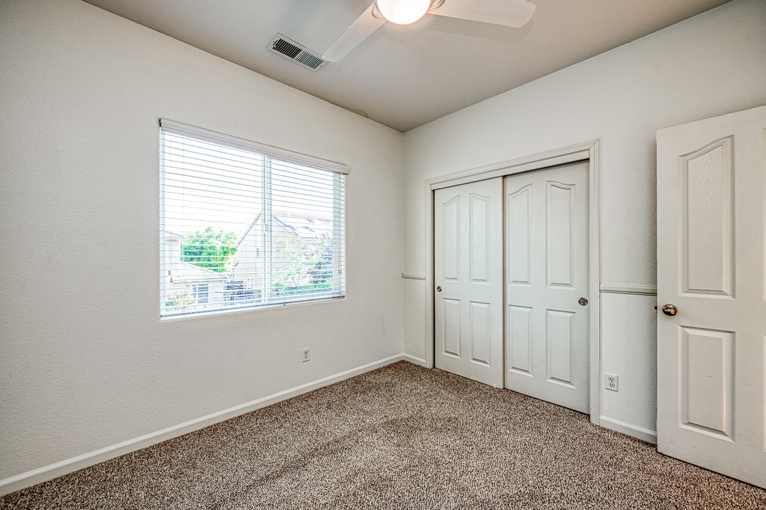 487 Everglade Avenue Clovis, CA 93619 - Photo 13 of 28 an empty room with windows and closet
