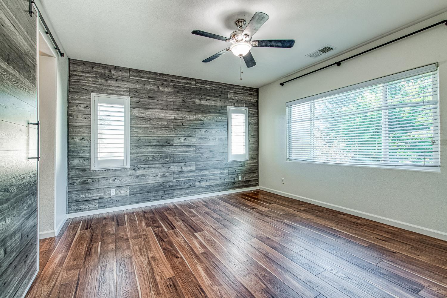 487 Everglade Avenue Clovis, CA 93619 - Photo 17 of 28 a view of an empty room with wooden floor and a window
