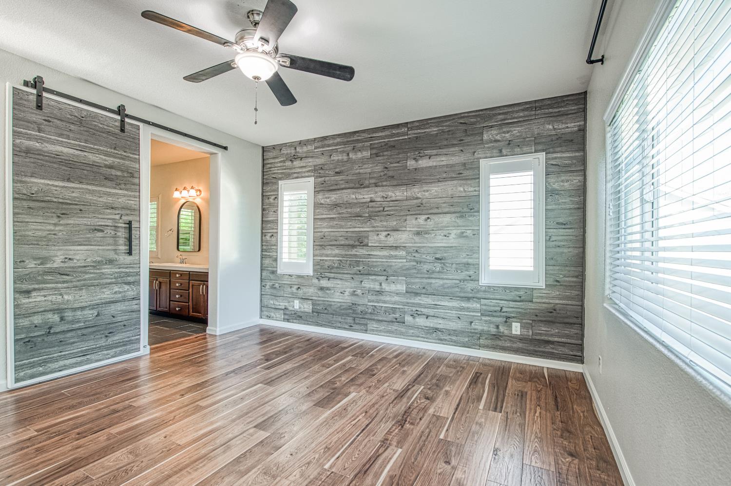 487 Everglade Avenue Clovis, CA 93619 - Photo 18 of 28 a view of a room with wooden floor and ceiling fan