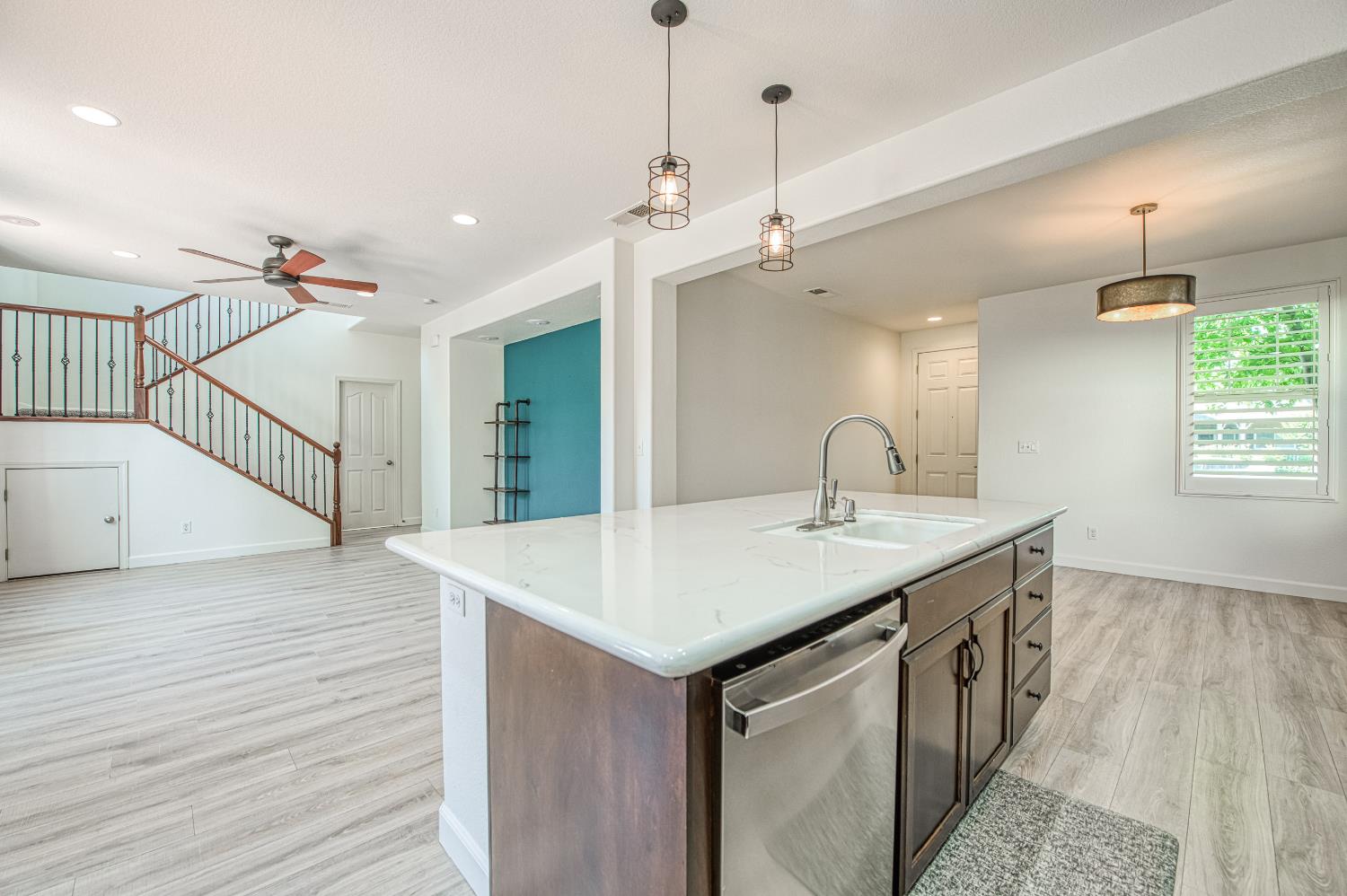 487 Everglade Avenue Clovis, CA 93619 - Photo 6 of 28 a kitchen with a sink and chandelier
