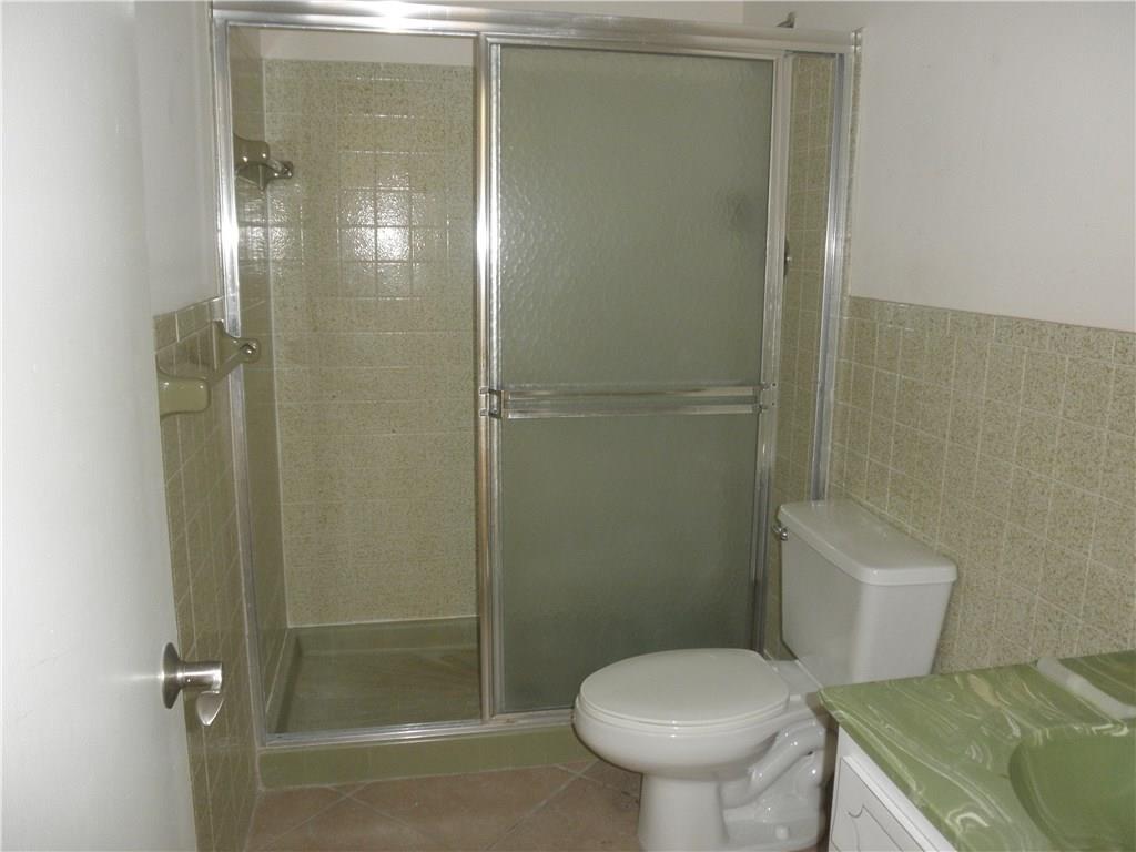 540 South Manor Drive Stuart, FL 34994 - Photo 18 of 22 a bathroom with a toilet and a shower