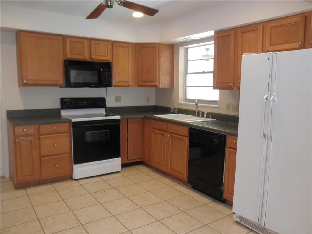 540 South Manor Drive Stuart, FL 34994 - Photo 7 of 22 a kitchen with a sink stove and microwave