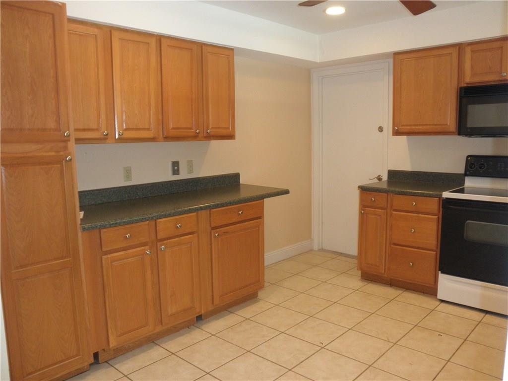 540 South Manor Drive Stuart, FL 34994 - Photo 8 of 22 a kitchen with stainless steel appliances granite countertop a sink stove and cabinets