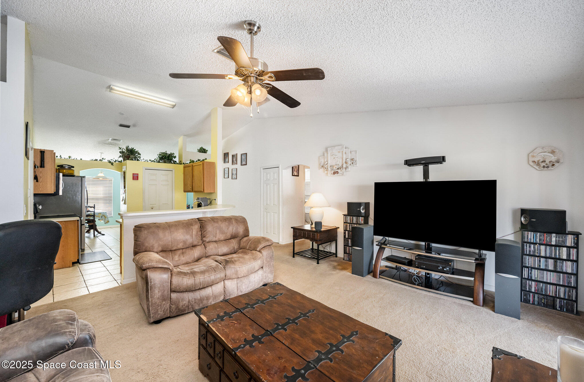 6170 Clearfield Avenue Cocoa, FL 32927 - Photo 12 of 24 a living room with furniture and a flat screen tv