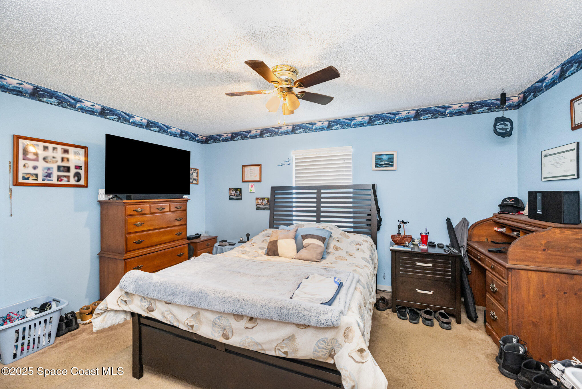6170 Clearfield Avenue Cocoa, FL 32927 - Photo 14 of 24 a bedroom with a bed and a flat screen tv