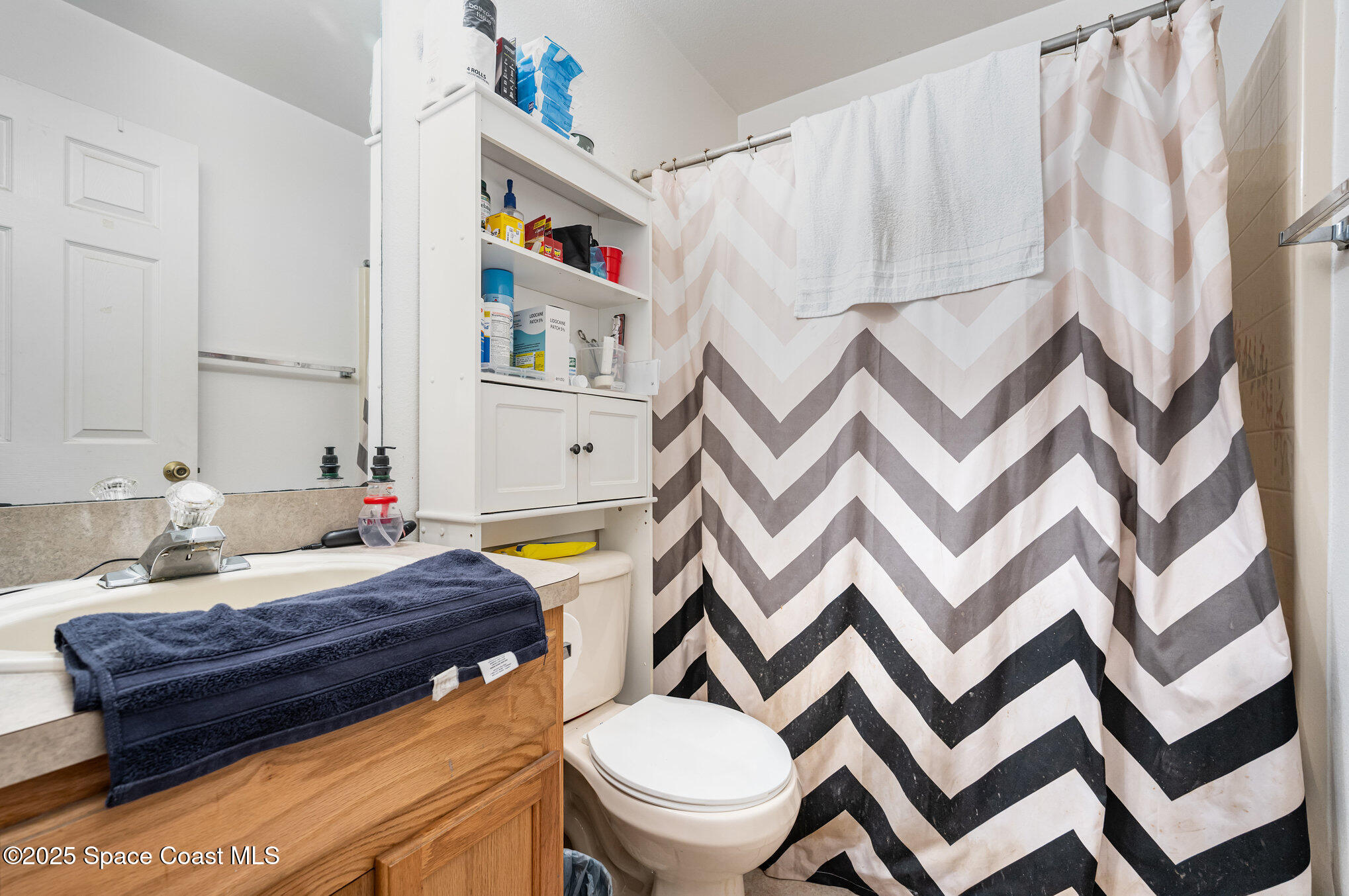 6170 Clearfield Avenue Cocoa, FL 32927 - Photo 17 of 24 a bathroom with a sink and a mirror