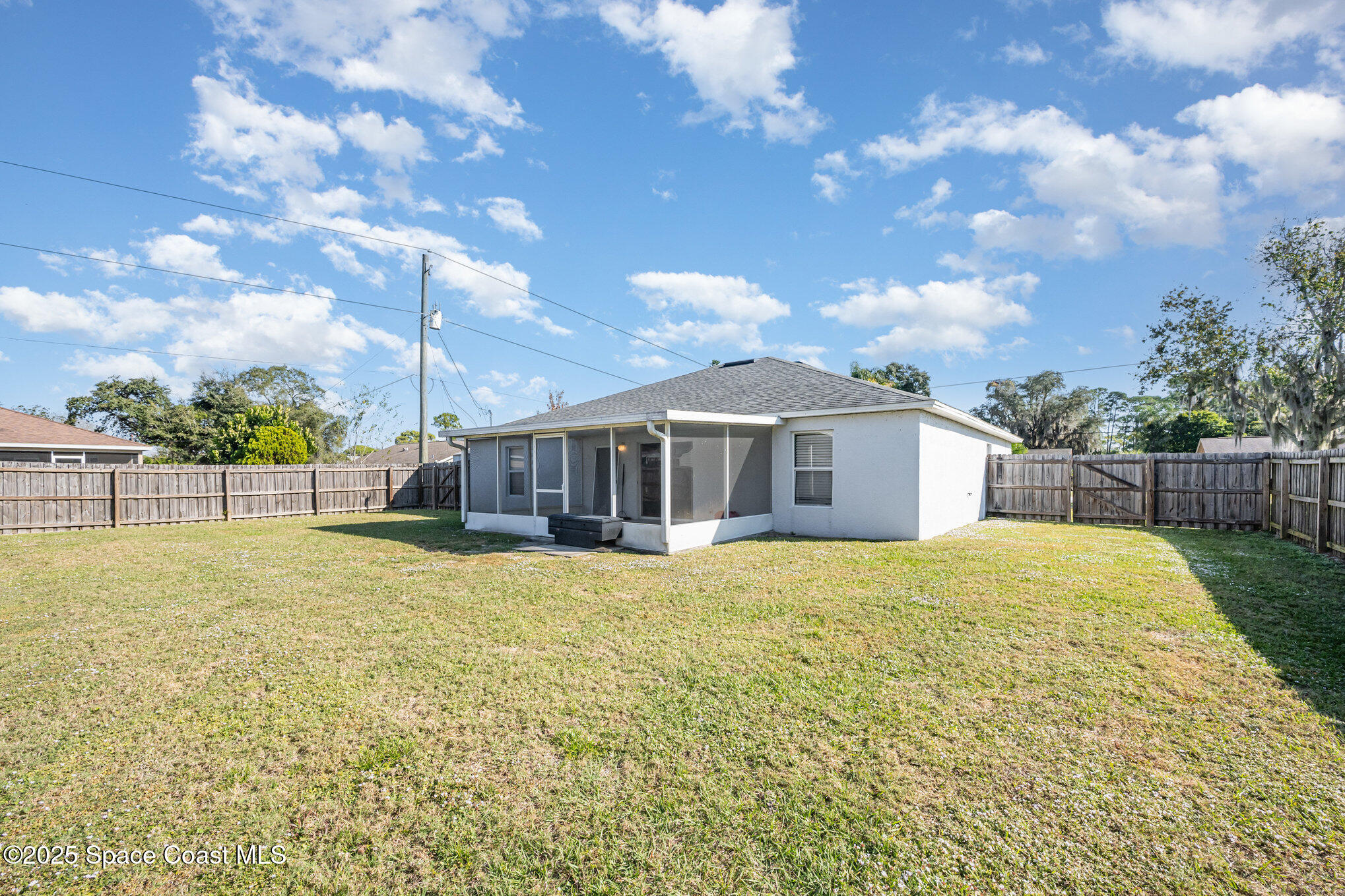6170 Clearfield Avenue Cocoa, FL 32927 - Photo 22 of 24 a yellow house with yard in front of it