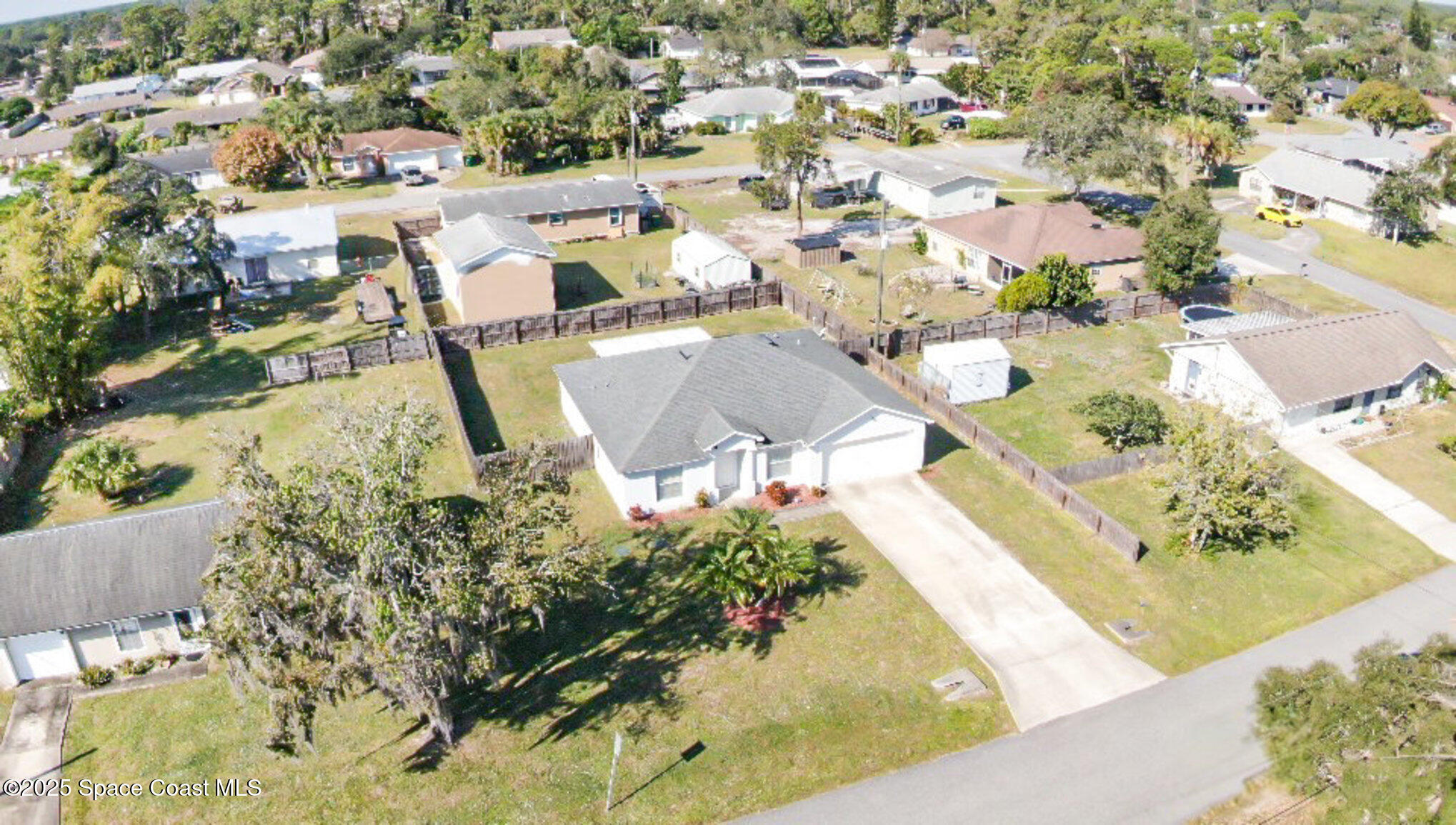 6170 Clearfield Avenue Cocoa, FL 32927 - Photo 23 of 24 an aerial view of a house with a yard and lake
