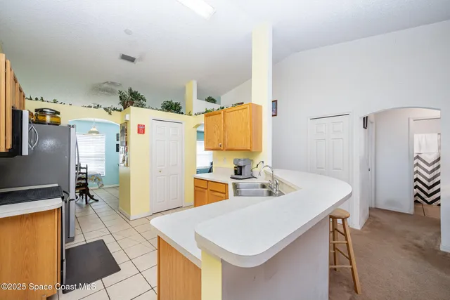 a kitchen with a sink appliances and cabinets