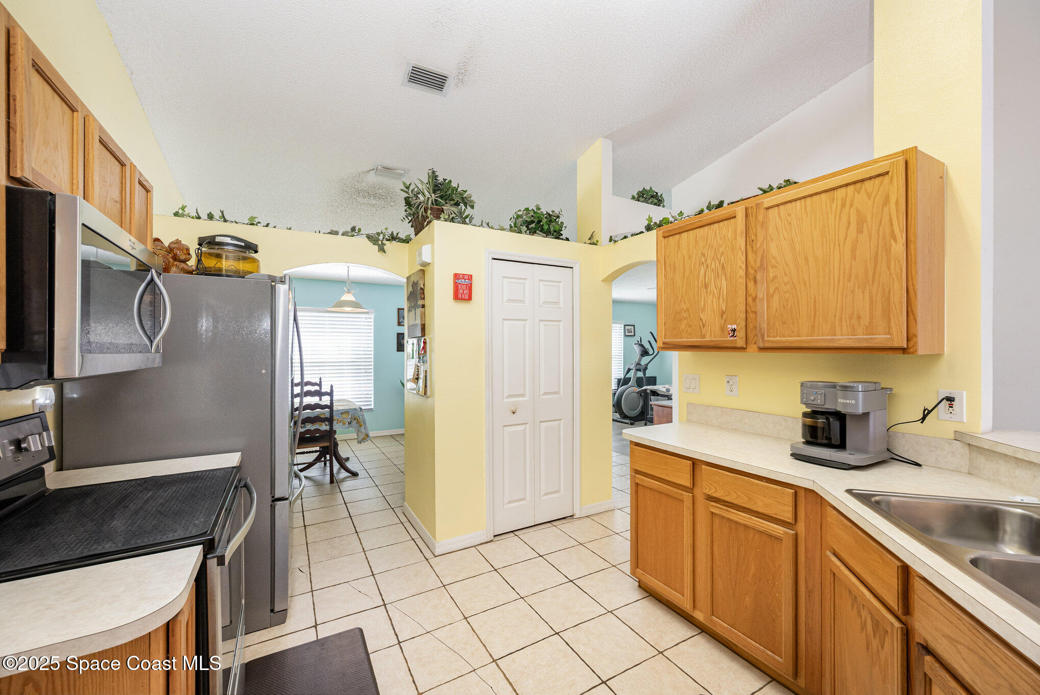 6170 Clearfield Avenue Cocoa, FL 32927 - Photo 5 of 24 a kitchen with a sink appliances and cabinets